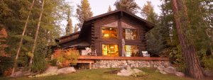 Log home with bright lit windows